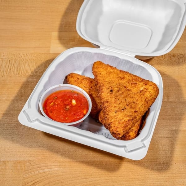 Two golden-brown fried mozzarella triangles with a side of red marinara sauce in a white takeout container.